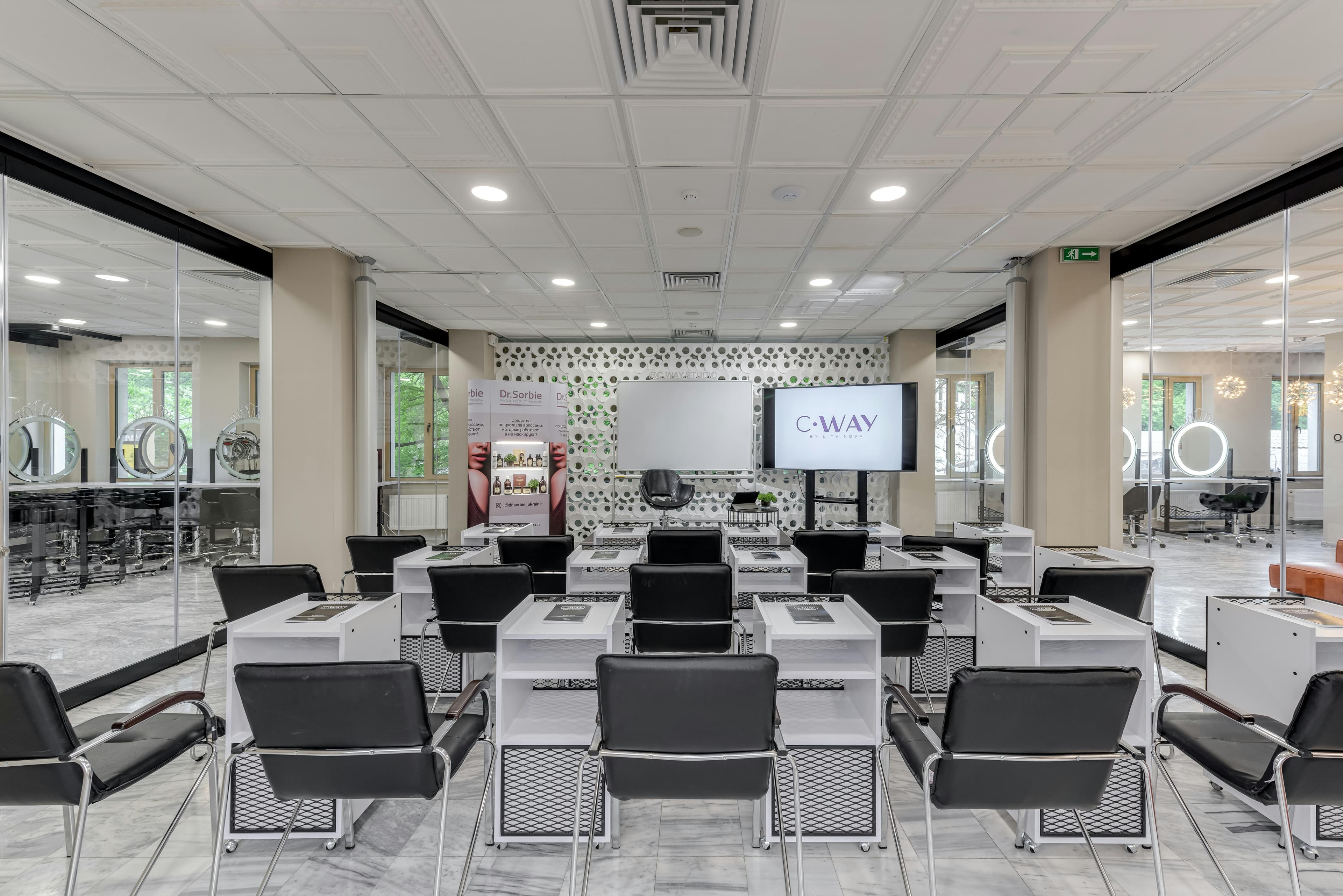Beauty school classroom with training stations
